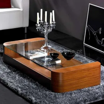 Mesa de centro on em madeira com tampo de vidro, castiçal e utensílios decorativos.