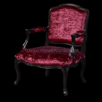 Cadeirão chique em veludo vermelho com estrutura de madeira escura e braços curvados