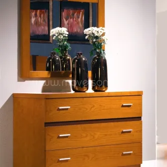 Cómoda em madeira clara com espelho e três gavetas, decoração com vasos e flores.