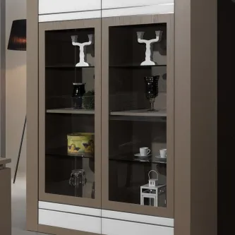 Vitrine Lille em madeira bege com portas de vidro e prateleiras com objetos decorativos