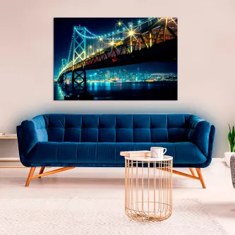 Quadro da ponte Golden Gate iluminada à noite sobre sofá azul