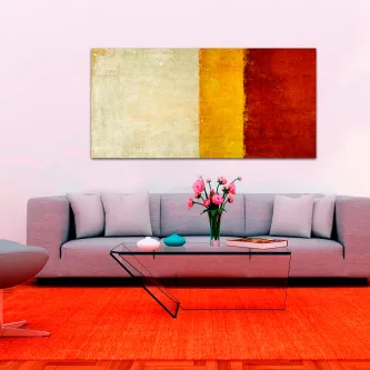 Quadro listrado a três com faixas verticais creme, amarelo e vermelho sobre sofá