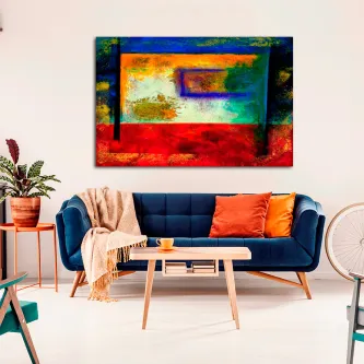 Quadro ousado abstrato colorido pendurado sobre sofá azul com almofadas laranja