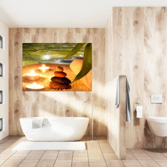 Quadro spa e velas com pedras empilhadas e velas acesas sobre banheira