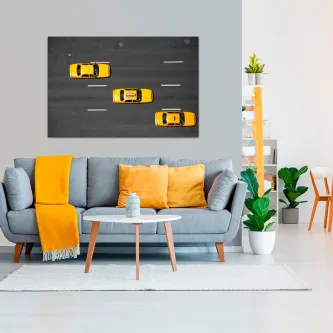 Quadro com vista aérea de três táxis amarelos numa estrada urbana