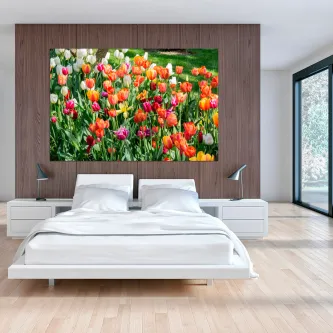 Quadro de campo de tulipas coloridas pendurado acima da cama em quarto moderno