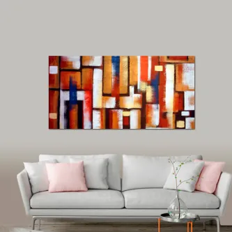 Pintura abstrata de cores com blocos geométricos em tons quentes pendurada sobre sofá cinzento