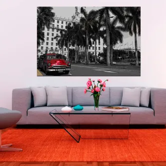 Carro clássico vermelho numa rua em Cuba com palmeiras e edifício, quadro sobre sofá
