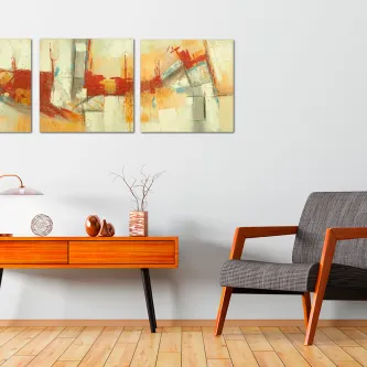 Pintura abstrata de tríptico em tons amarelo, laranja e vermelho sobre parede branca
