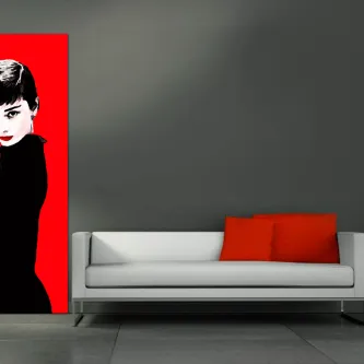 Pintura vermelha com retrato feminino pop art na parede, sofá branco com almofadas vermelhas