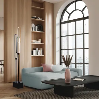 Candeeiro de pé Colette XXL preto junto a sofá azul e janela arqueada