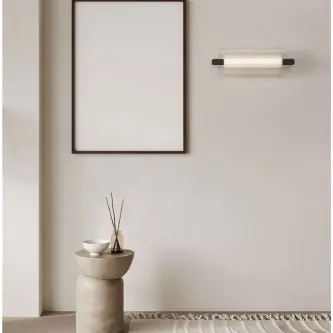 Aplique Emery branco com extremos pretos montado na parede acima de pedestal decorativo