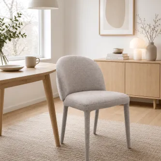 Cadeira cinzenta estofada moderna junto a mesa de madeira numa sala luminosa