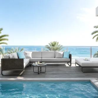 Sofá canto de jardim com puff Star cinzento junto a piscina e vista de mar