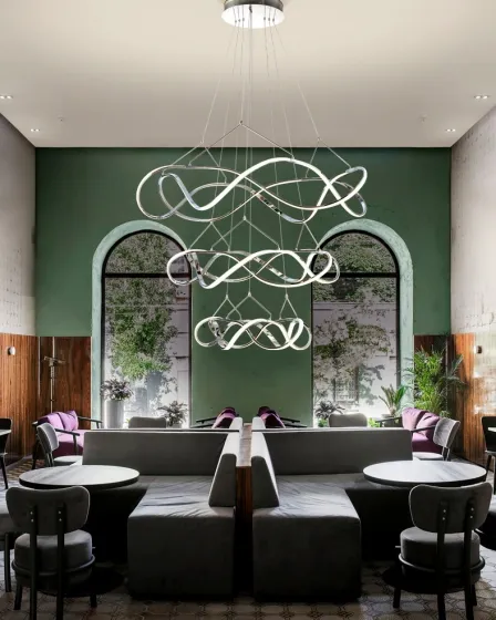 Candeeiro de teto Molly 3A com anéis LED entrelaçados numa sala lounge moderna