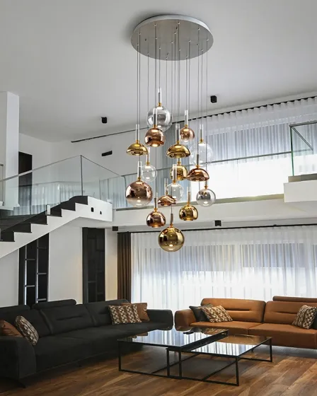 Candeeiro de teto Charlize 16l com 16 pendentes metálicos dourados e cobre sobre sala