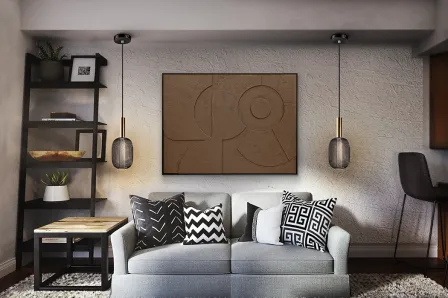 Quadro Morphos castanho abstrato sobre sofá cinzento com almofadas pretas e brancas