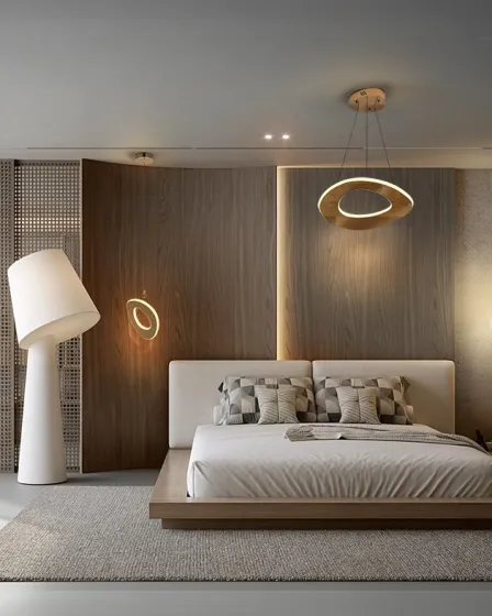 Candeeiro de teto Mirena pendente circular dourado sobre cama minimalista.