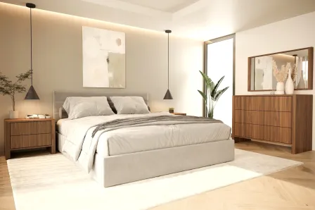 Cama de casal estofada baixa com pés, colcha bege, candeeiro suspenso e cómoda