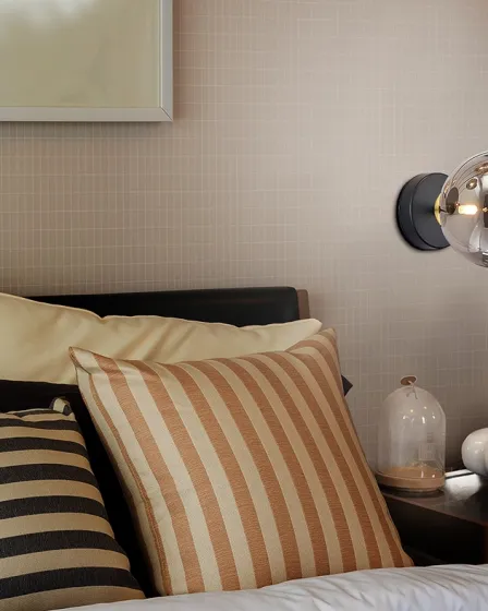 Aplique Dark metálico com globo de vidro iluminado junto à cabeceira