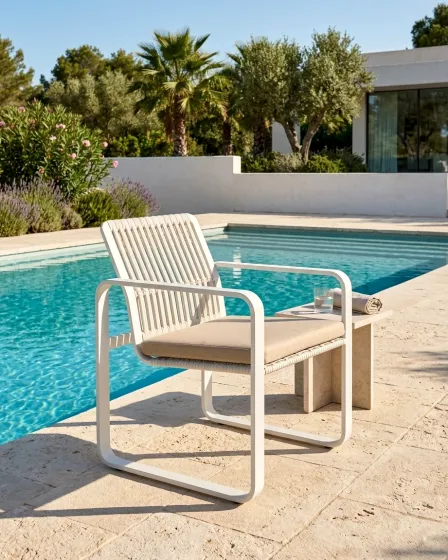 Cadeirão de jardim Cires branco com almofada bege junto à piscina