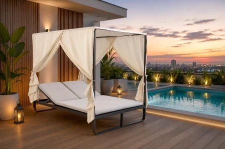 Espreguiçadeira dupla com cortina branca junto à piscina ao pôr do sol