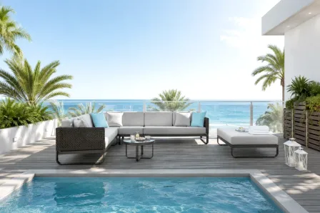 Sofá canto de jardim com puff Star cinzento junto a piscina e vista de mar