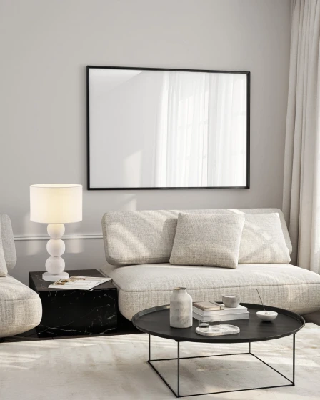 Candeeiro de mesa chamois branco com base de bolas e abat-jour cilíndrico junto ao sofá